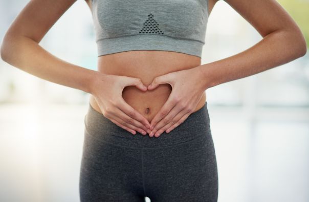 woman holding her belly - gut health.