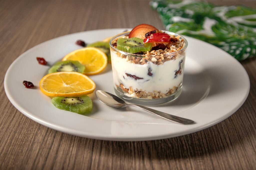 yogurt with sliced lemon on white ceramic plate