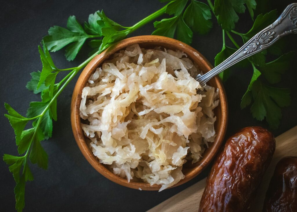 a wooden bowl filled with sauerkraut