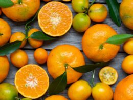 orange fruits on gray wooden surface